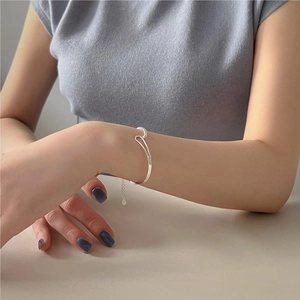 Minimalist S925 sterling silver cuff bracelet with sleek bead detail on model wrist