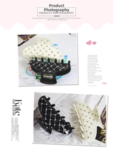 Detail of elegant checkered hair claws with sparkling rhinestones in black and cream beige