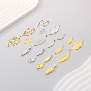 Detailed view of DIY hollow leaf pendants in gold and silver finish for jewelry making