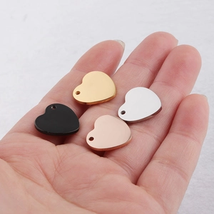 Macro shot of heart shaped pendants in gold silver rose gold and black steel