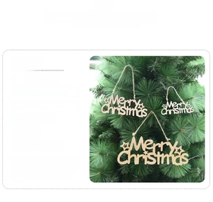 Detailed view of Merry Christmas hollow wooden ornaments in three sizes hanging on a tree