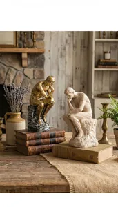 Detail view of retro sandstone thinker statues in gold and cream on vintage books