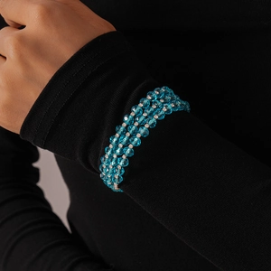 Detail of three-layer sky blue beaded bracelet with silver rhinestone spacers on wrist