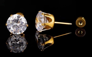 Macro shot of 18k gold plated stud earring with round cubic zirconia and screw-back detail
