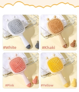 Detail of four colorful cartoon bee hair brushes with matching cleaning tools and soft bristles