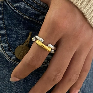 Model wearing two-tone stainless steel zircon ring against dark denim fabric