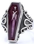 Macro detail of Gothic coffin ring featuring purple inlay and ornate skeleton engraving