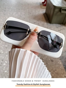 Detailed view of rimless star sunglasses with silver star rivets and slim metal temples