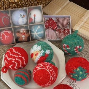 Handmade Christmas tree ornaments with wool felt and knitted yarn balls in festive colors