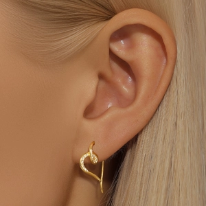 Close-up of S925 silver heart earring in gold finish with sparkling pavé cubic zirconia