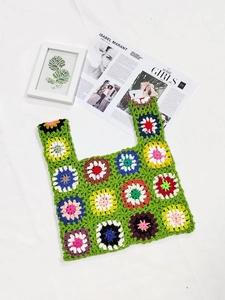 Macro shot of colorful granny square crochet tote bag with bohemian floral stitching
