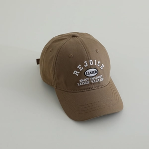 Detailed close-up of brown cotton baseball cap with white REJOICE embroidery