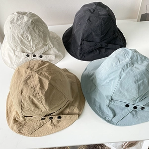 Detail view of lightweight nylon sun hats in cream, black, khaki, and light blue colors