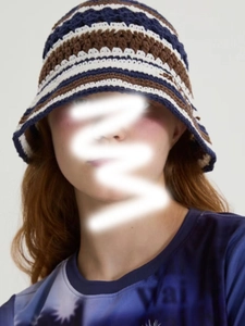 Detailed knit texture of a handmade crochet bucket hat with navy and beige stripes