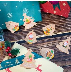 Detailed view of kraft paper Christmas gift tags with festive Santa and reindeer illustrations