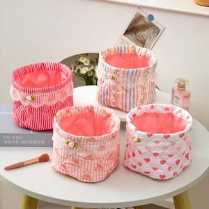 Set of four quilted fabric storage baskets with floral patterns and lace trim for desks