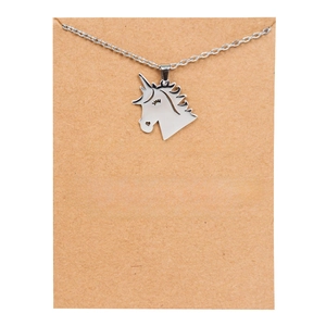 Silver unicorn necklace with Life is Magical message card on craft paper background
