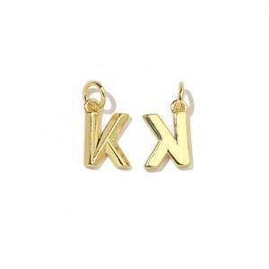 Detail of 18K gold plated letter charms K and X with polished finish for DIY jewelry making