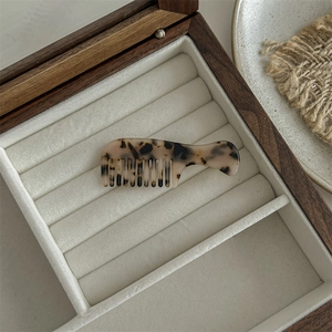 Detailed view of large leopard print acetate hair claw with vintage tortoiseshell pattern