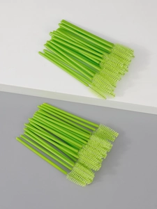 Detailed view of light green disposable eyelash brushes with spiral nylon heads for makeup