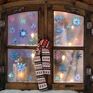 Colorful Christmas snowflake window stickers on glass pane with cozy Nordic winter decor