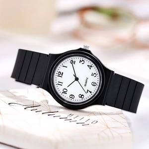 Close-up of minimalist black quartz watch with white dial on an Autumn Hello stand