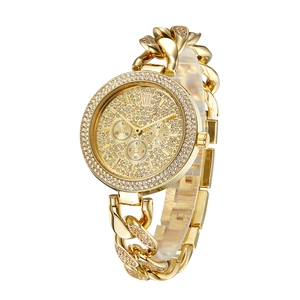 Close-up of gold iced-out watch featuring diamond-encrusted dial and Cuban chain strap