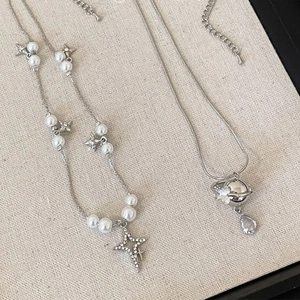 Sparkling zircon Saturn pearl necklace set with star and teardrop gemstone pendants