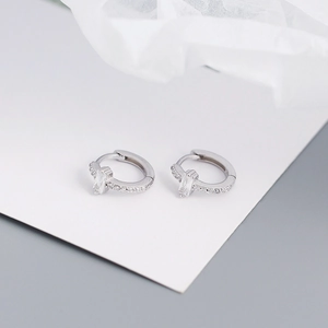 Macro detail of S925 silver hoop earring featuring a rectangular zircon and micro-pavé gems