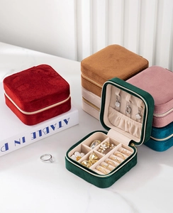 Detail view of colorful velvet jewelry organizers with rings and necklace compartments