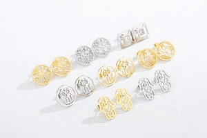 Detailed view of eight pairs of gold and silver stainless steel geometric stud earrings
