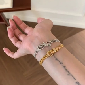 Close-up of 14K gold and silver plated horseshoe buckle bracelets with zircon stones