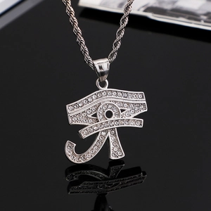 Macro shot of silver Horus eye pendant with sparkling zircons on a twisted rope chain