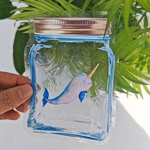 Holographic narwhal glass sticker suncatcher showing colorful rainbow prism light effects