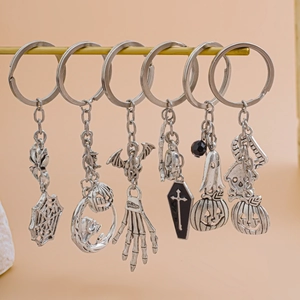 Set of 6 silver Halloween keychains featuring spider web skull and pumpkin charms