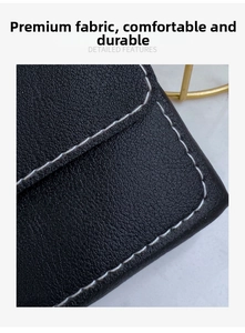 Close-up of black lychee texture leather with white stitching and durable fabric detail