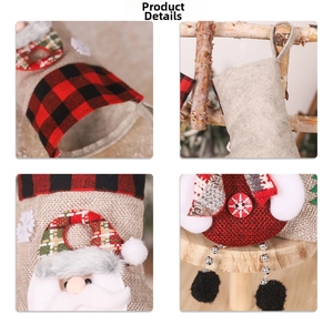 Detail of burlap Christmas stocking featuring Santa Claus motif and plaid pattern fabric