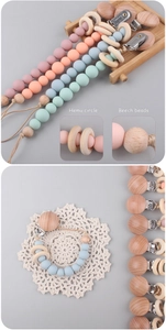 Detail of wooden rings and beads on silicone pacifier clip in Morandi colors