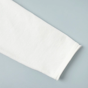 Detailed macro view of white knitted fabric texture with minimalist rolled hem finish