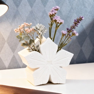 Detail of white snowflake silicone mold for creating floral basket plaster ornaments