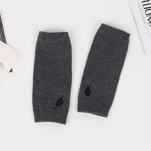 Detailed knit texture of dark grey fingerless arm warmers with thumb hole design