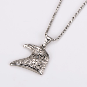 Macro view of hip hop eagle head pendant with embossed textures and snake chain