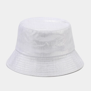Detailed view of white bucket hat featuring metallic laser finish and textured fabric