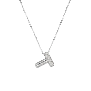 Macro detail of silver bubble letter T pendant with micro-pave cubic zirconia stones