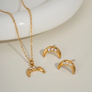 Golden moon jewelry set with sparkling crystals including crescent necklace and stud earrings