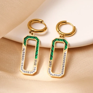Detail view of gold rectangle earrings with green-black stripes and white cubic zirconia