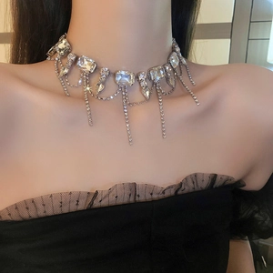 Close-up of silver choker necklace with rhinestones and fringe tassels on a model