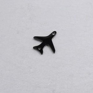 Close-up of a black mirror-polished stainless steel airplane pendant with two holes for DIY