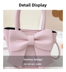 Detailed close-up of a pink crossbody bag featuring a large bow and fine PU leather texture