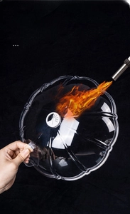 Heat resistance test showing clear microwave plate cover enduring high temperature flame